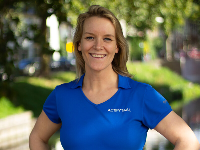 Profielfoto van fysiotherapeut Brigitte van Engelen die in een blauw shirt poseert voor de camera.